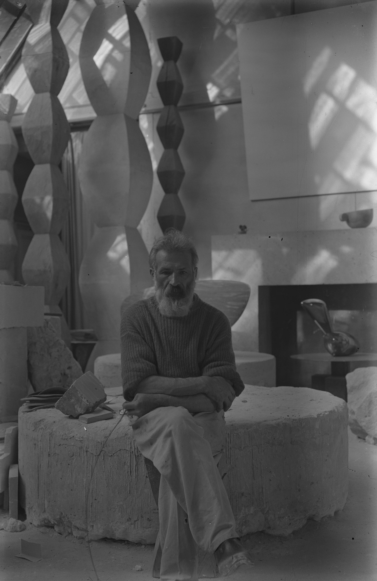 Constantin Brancusi. Self-portrait in the studio with Endless Columns I–IV, Fish (1930), Leda (1926). c. 1934. Glass negative, 5 7/8 × 3 15/16" (15 × 10 cm). Centre Pompidou, Paris, Musée national d’art moderne-Centre de création industrielle, Constantin Brancusi Bequest, 1957. PH 854. Digital Image © CNAC/MNAM, Dist. RMN-Grand Palais / Art Resource, NY. © Succession Brancusi – All rights reserved (Adagp).